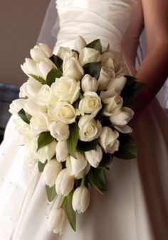 a bridal holding a bouquet of white flowers