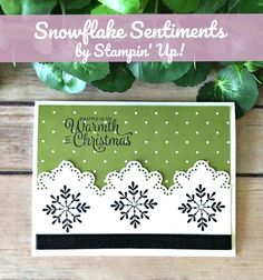 snowflake sentiments by stampin'up on a wooden table with green leaves