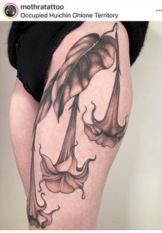 a woman's thigh with tattoos on it