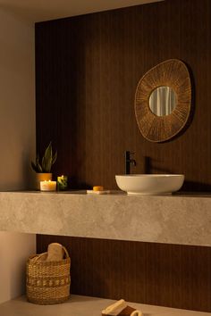 a bathroom with a sink, mirror and towel on the counter top in front of it