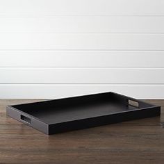 a black tray sitting on top of a wooden table