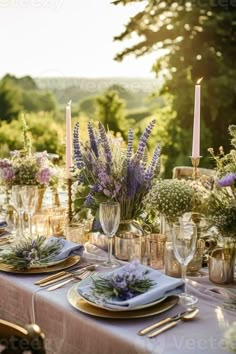 the table is set with purple flowers and candles