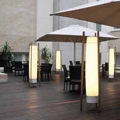 an outdoor dining area with tables and umbrellas