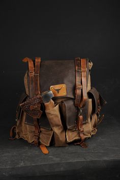 a brown and tan bag sitting on top of a black table next to a knife