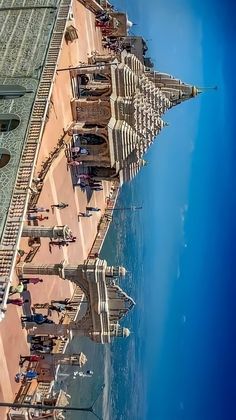 the view from an airplane looking down at some buildings and water in front of them