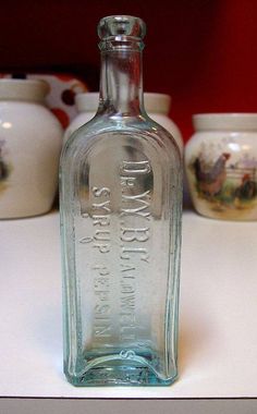 a glass bottle sitting on top of a table