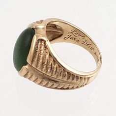 "This striking 14K gold ring features a large green jade stone and an engraved band that resembles a stylized fern or feather. Just the right combination of style and masculinity! Note that the inside of this ring has a lovers inscription and date 1974. Style: Classic, Masculine Vintage: 1970s Materials: 14K Gold, Green Jade Size: 10 Green Jade: 16mm x 12mm Width North to South: approx. 3/4\" Weight: 7.5 dwt / 11.6 g Condition: Very Good ASK ABOUT OUR FREE LAYAWAY! FREE FULLY INSURED PRIORITY SH Formal Green Engraved Signet Ring, Heirloom Green 14k Gold Signet Ring, Antique Green Rings With Polished Finish, Antique Green Emerald Ring With Polished Finish, Green Carved Rings For Formal Occasions, Vintage Green Signet Ring With Polished Finish, Engraved Oval Green Emerald Ring, Oval Engraved Green Emerald Ring, Formal Carved Green Ring