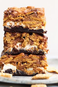 three dessert bars stacked on top of each other with chocolate and marshmallows