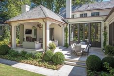 a house with a covered patio and outdoor dining area