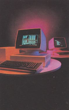 an old computer with two monitors and a keyboard