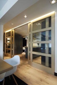 an open glass door leading into a dining room