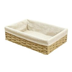 a wicker dog bed with white dots on the top and bottom, sitting in front of a white background