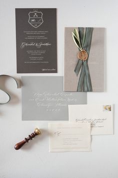 the wedding stationery is laid out neatly on the wall