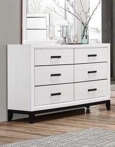 a white dresser sitting on top of a hard wood floor