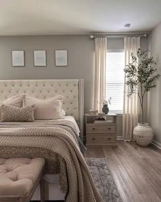 a bedroom with a bed, dressers and window in it's center area