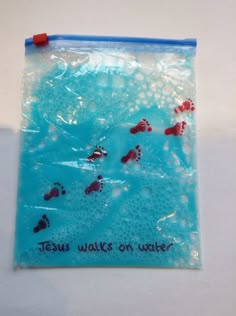 there is a plastic bag with red footprints on it that says jesus walks on water