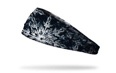 a black and white tie dye headband with snowflakes printed on the side