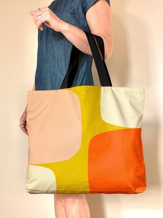 "Meet my mid century style Abstract Shapes bag, a large tote bag in warm neutral and gold, pink and orange. This oversized tote bag with a retro Scandinavian design bag has zillion use If you're a fan of oversized totes, look no further -great for market, travel, gym, beach and overnight Check out the handy wallet sized pockets on the inside, the bag is fully lined with a snap closure. This colorful bag is a great girlfriend or hostess gift, mostly I'm seeing folks nab them for theirselves (enco Large Capacity Retro Canvas Shoulder Bag, Retro Canvas Shoulder Bag, Retro Orange Everyday Bag, Retro Canvas Bag With Large Capacity For Shopping, Retro Large Capacity Canvas Shopping Bag, Retro Orange Shoulder Bag For Everyday, Retro Canvas Bag With Large Capacity For Daily Use, Retro Multicolor Tote Canvas Bag, Retro Rectangular Bags For Weekend