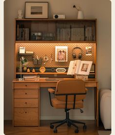 an office with a desk, chair and bookshelf in front of the wall