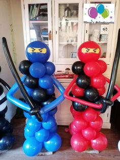 two balloon sculptures made to look like ninjas with swords and balloons in the shape of people