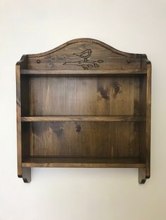 a wooden shelf with two birds on it