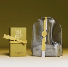 a silver bag with a yellow ribbon next to it