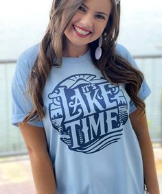 Introducing our "It's Lake Time" Graphic Shirt, a must-have for all lake lovers and those who cherish the serenity of lake life. Available in sizes YXS to 5XL, this shirt offers a comfortable and flattering fit for everyone, making it an ideal choice for your lake adventures.
The design features the phrase "It's Lake Time" in a stylish navy font, perfectly contrasting against a light blue shirt. This classic and elegant color combination captures the essence of peaceful lake days and fun boat ri Time Graphic, Lake Days, Light Blue Shirt, Lake Time, Black Friday Christmas, Boat Ride, Elegant Color, White Headband, Light Blue Shirts