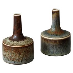 two brown vases sitting next to each other