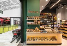 the inside of a grocery store filled with lots of food and drink bottles on shelves