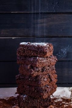 chocolate keto fudgey brownies stacked on top of each other with the text overlay