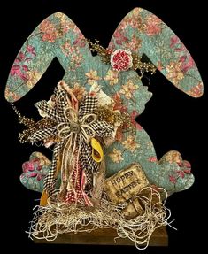 an image of a decorative rabbit made out of fabric and paper machs with flowers on it