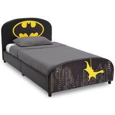 a bed with a batman headboard and foot board on it's side,