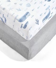 an image of a baby bed with blue and white sheets