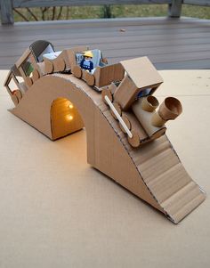 an open cardboard box shaped like a tunnel