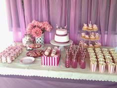 a table topped with lots of desserts and cupcakes