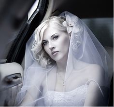 a bride sitting in the back seat of a car