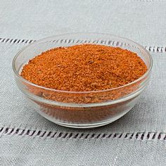 a glass bowl filled with spices on top of a table