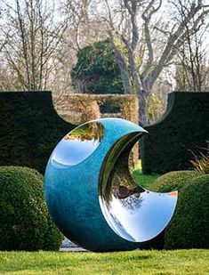 a sculpture in the middle of a grassy area