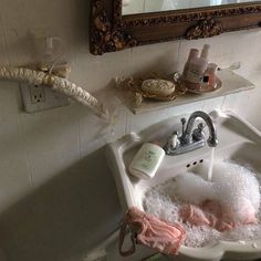 a bathroom sink with soap and lotion in it