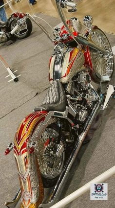 a red and white motorcycle parked on top of a floor