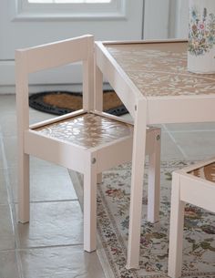 two wooden chairs sitting next to each other on top of a rug