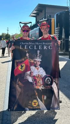 two men in costumes holding up a sign with the words le clerc on it