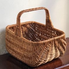 a wicker basket sitting on top of a wooden table