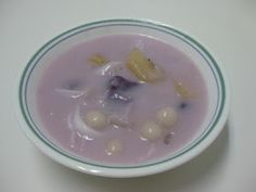 a bowl filled with food sitting on top of a table next to a white surface