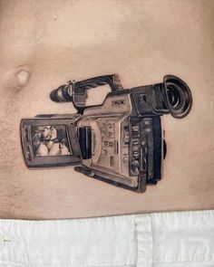 a man with a camera tattoo on his stomach