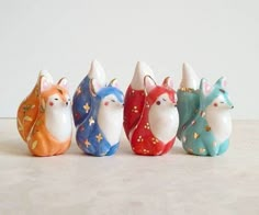 small ceramic figurines are lined up in a row