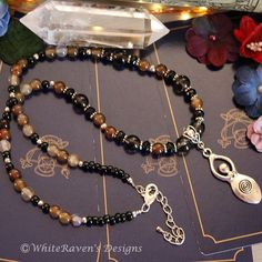 A one of a kind, spiral goddess, earth witch necklace created with Agate, smoky quartz and onyx natural crystal stone beads and a silver goddess deity pendant. The spiral goddess is a powerful symbol for women, representing the divine feminine energy and the cycles of life. It's a beautiful reminder of the power of nature and our connection to it.    Not only a beautiful Boho witch accessory goddess necklace, suitable as witchcraft wicca witchy gifts for a loved one or a special addition to your Adjustable Mystical Gemstone Beads Necklace, Adjustable Mystical Gemstone Beaded Necklace, Mystical Necklaces With Natural Stones For Healing, Adjustable Mystical Necklace With Gemstone Beads, Mystical Healing Crystal Necklaces With Gemstone Beads, Handmade Agate Beaded Necklace Spiritual Style, Mystical Adjustable Gemstone Beads Necklace, Mystical Healing Crystal Necklace With Gemstone Beads, Spiritual Brown Crystal Necklaces For Healing