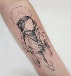 a woman's arm with an abstract tattoo design on the left side of it