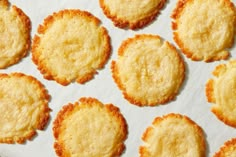 small cookies are arranged in rows on a white paper towel and placed on top of each other