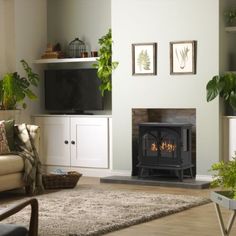 a living room filled with furniture and a fire place in front of a flat screen tv